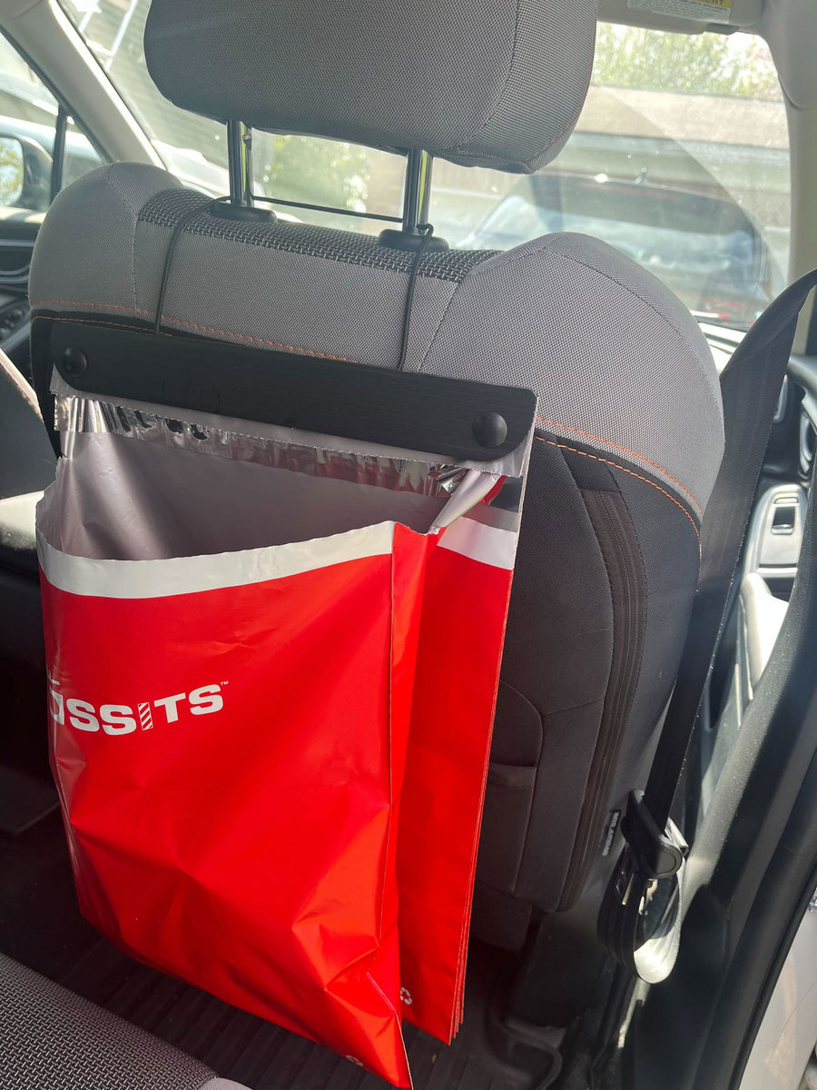 Red Tossits bag hanging from a headrest, photographed by customer Amelia D.