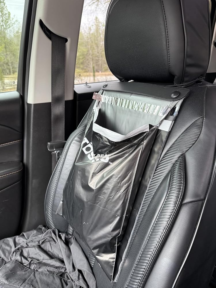 Black Tossits bag hanging from a headrest, photographed by customer Jamie Y.