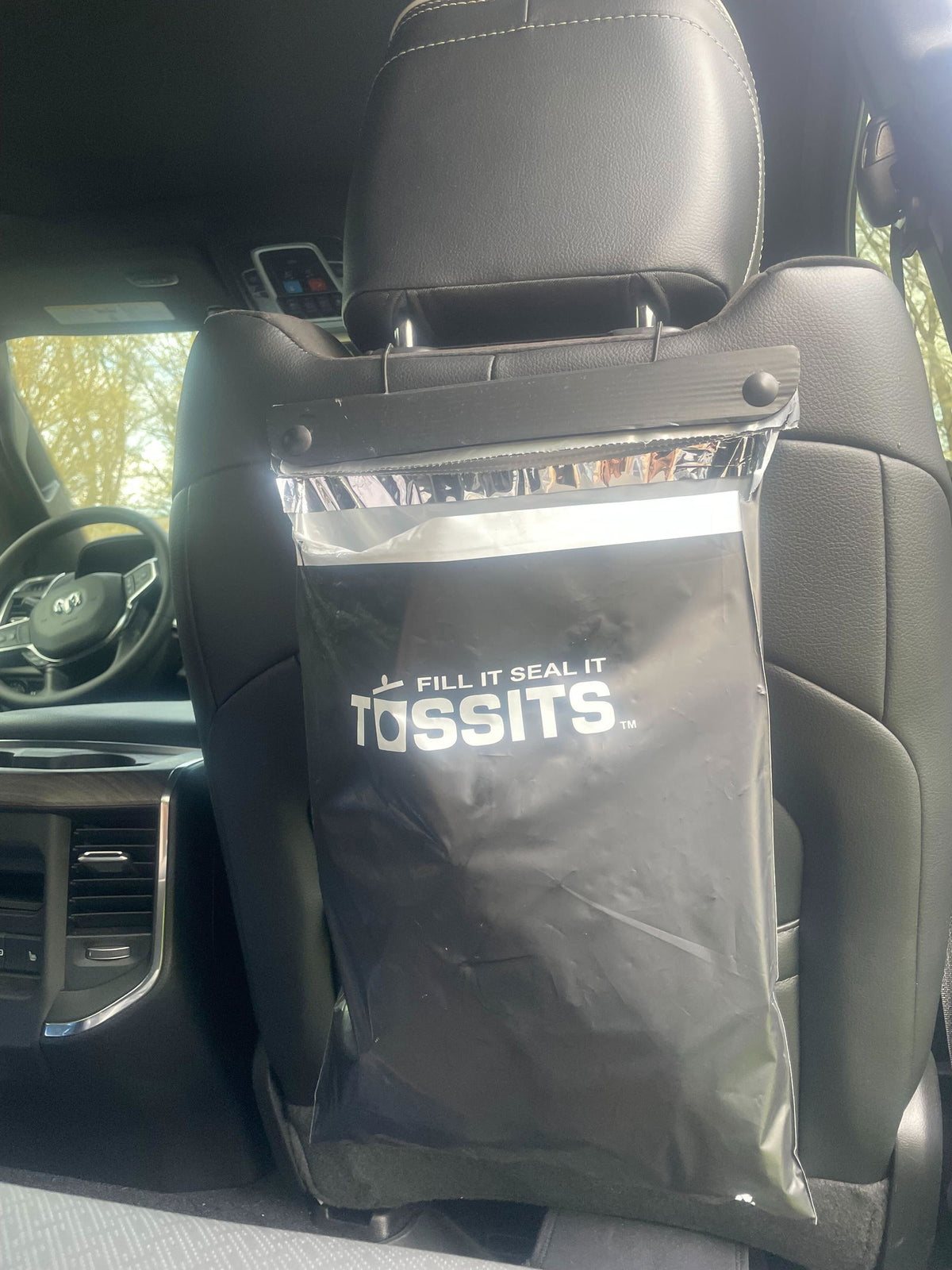 Black Tossits bag hanging in a customer's car